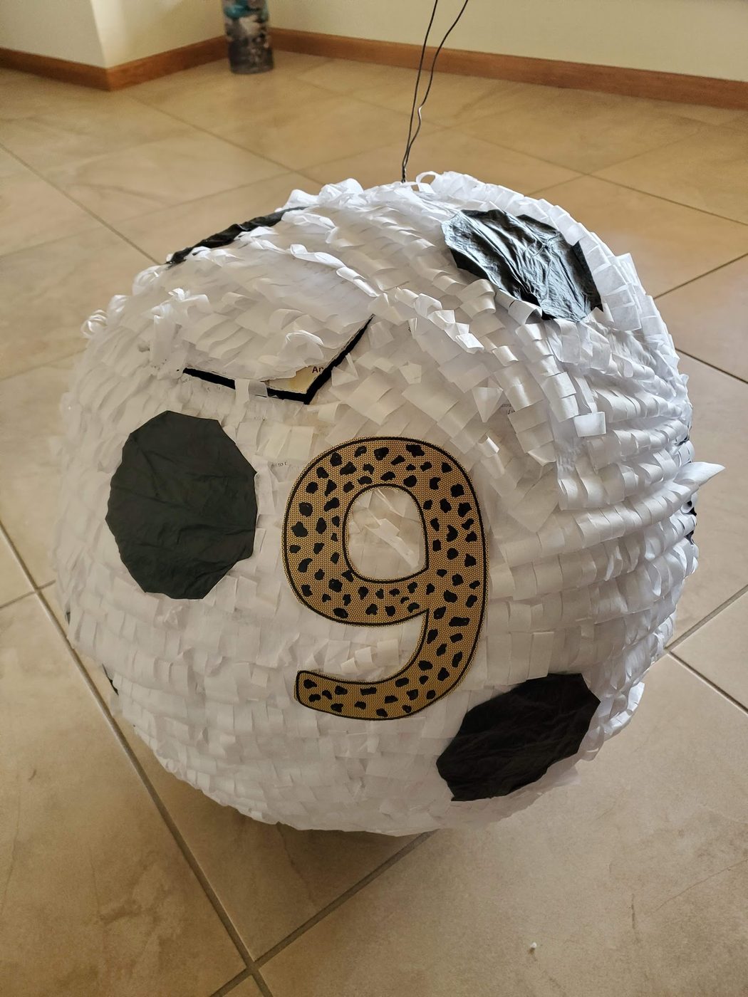 A hand-decorated soccer-ball piñata for a party.